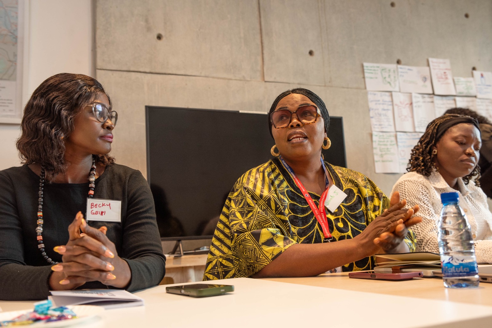 three person holding beverage cups